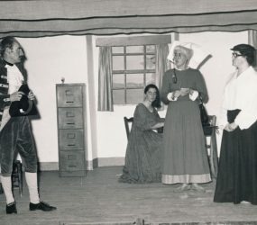 Cast performing on stage