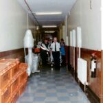 patient wheeled down corridor full of packing crates
