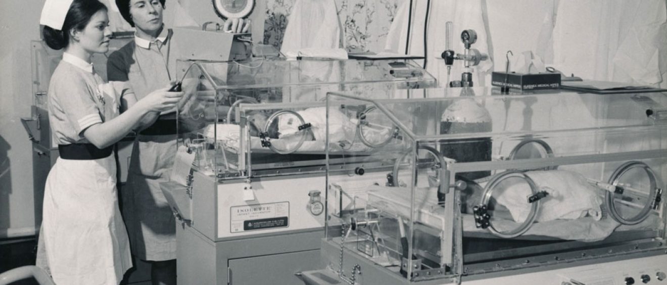 Staff midwife with student and babies in incubators