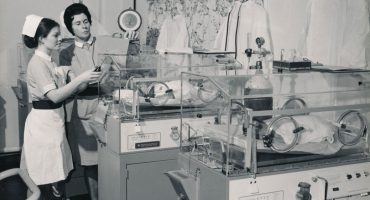 Staff midwife with student and babies in incubators