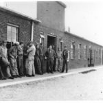 soldiers lined up against wall of mess hall