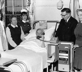 Chairman Ray Annetts with patient in bed using the new telephone