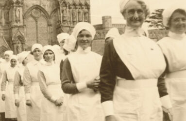 Black and white photograph of nurses in 1920 uniforms in a parade