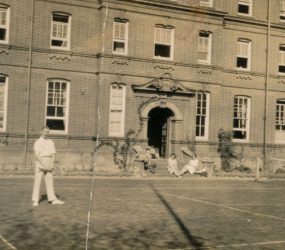 Dr Bernard Alexander playing tennis on courts outside Victoria Nurses Home, 1928