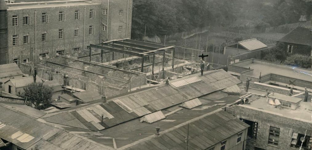 Hospital viewed from roof,showing temporary hutted buildings