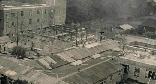 Hospital viewed from roof,showing temporary hutted buildings