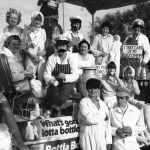 Staff dressed as milkmen carrying pints - banner on float reads 'what's gotta lotta bottle?'