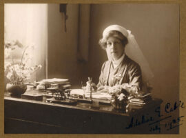 Adeline sat at writing desk