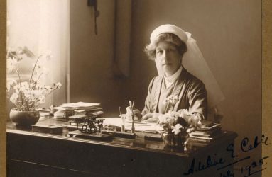 Adeline sat at writing desk