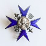 metal badge with eight point blue cross with portrait of Florence Nightingale centre