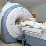 nurse standing by patient preparing to enter MRI scanner