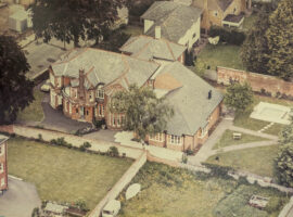 Colour aerial photograph showing large red brick house and town lawns