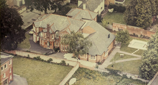 Colour aerial photograph showing large red brick house and town lawns