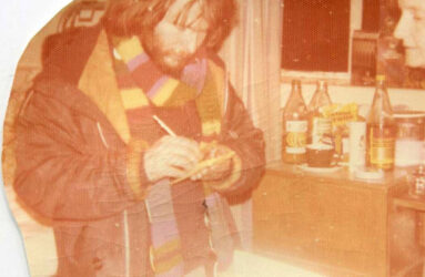 Faded colour photograph of Bill Oddie signing autographs