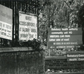 Signs on entrance wall incl 'nearest A&E at Infirmary'