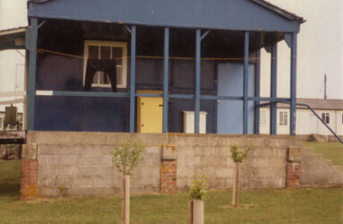 a colour photograph of blue hut raised up on platform
