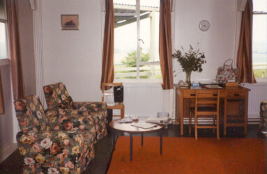 A colour photo of lounge interior and floral pattern seating