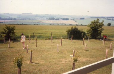 a colour photo of grass area and fields beyond