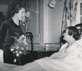 Princess Alexandra talking to woman patient in bed