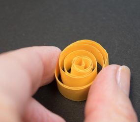 a coiled strip of yellow paper