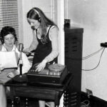 Black and white photograph of 2 women in radio station