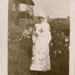 Nurse in uniform standing in the garden