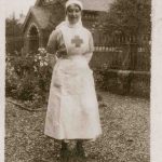 Nurse stands for photo in hospital garden