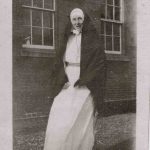 Sister poses in her nun's uniform