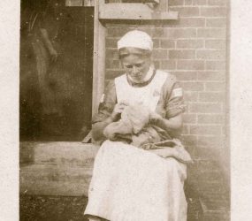 Nurse sewing on the steps to hospital