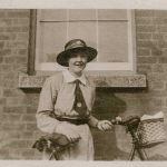 Nurse poses with her bike outside the hospital building