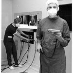 theatre staff demonstrate equipment, x-ray viewer on wall in background