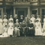nurses and staff pose outside pillared entrance to Finch House