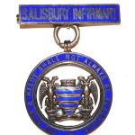 blue circle badge with Salisbury crest in centre and bar at top with words 'Salisbury Infirmary'