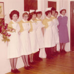 Colour photograph showing nurses in uniform lined up