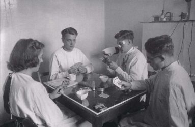 Black and white photograph showing a card game