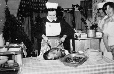 Sister Haines cutting turkey, with Senior Nurse Stralsic and Alice Hardwill