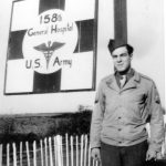 Soldier posing by the hospital sign
