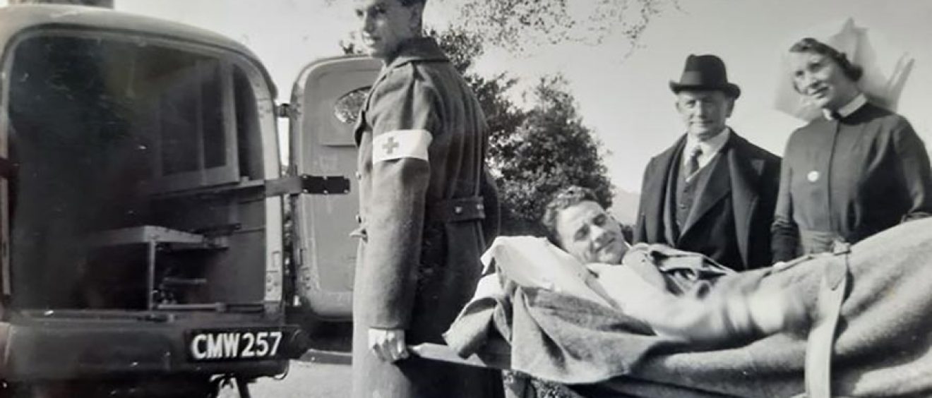 Gordon Richards being carried on stretcher towards back of ambulance