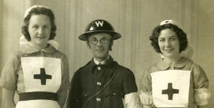 Sepia photo of 2 Red Cross Nurses and WW2 warden