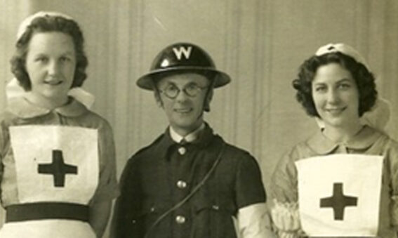 Sepia photo of 2 Red Cross Nurses and WW2 warden