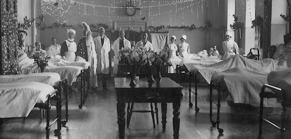Doctors and nurses show off decorated ward for Christmas, 1930s