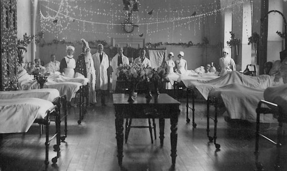 Doctors and nurses show off decorated ward for Christmas, 1930s