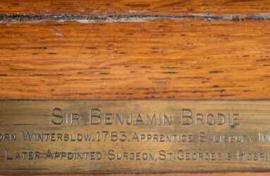 Close up photo of brass plaque on picture frame