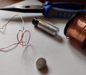 pliers, copper wire, AA battery, magnets