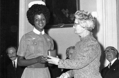 Nurse being presented with an award in a box