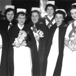 nurses in capes and white hats
