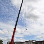 Crane lifting building into place