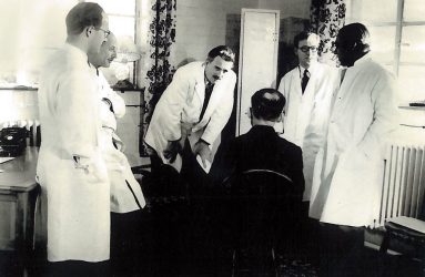 Dr Barron and colleagues consulting patient