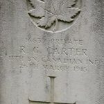 Close up of head stone with inscription and maple leaf