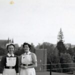 Black and white photo of nurses with Salisbury Cathedral spire in background